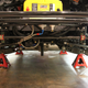 Under the rear of the car.
